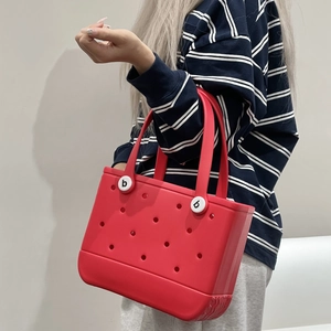 Detailed view of red EVA beach tote featuring a waterproof perforated hollow design