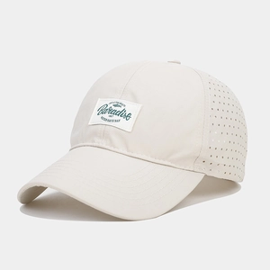 Detail view of quick-dry baseball cap with laser-cut holes and Paradise patch