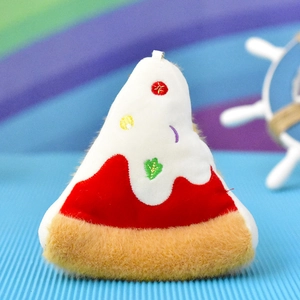 Detailed close-up of a triangular plush cake slice charm with soft faux fur texture.