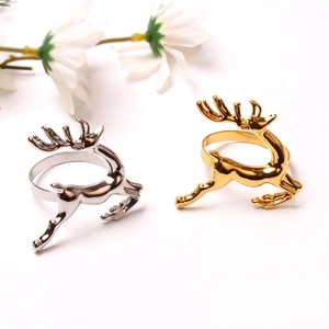 Close-up of gold and silver reindeer napkin rings with high-gloss metallic finish