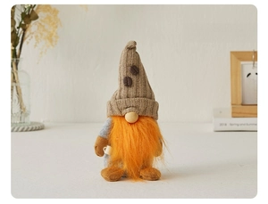 Detail of coffee gnome plush with knitted hat, orange beard and mini mug decoration