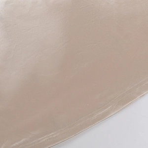 Macro shot of high-quality champagne satin fabric with precise double-needle stitching