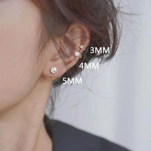 Detailed view of 3mm to 5mm gold plated stud earrings with round cubic zirconia
