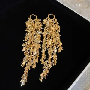Elegant gold leaf tassel drop earrings with cascading foliage design for a metallic finish