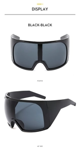 Macro view of oversized wraparound sports sunglasses in black frame and black lenses