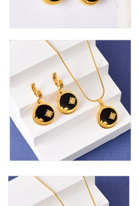 Detailed set of a gold sun flower necklace and earrings on a blue frosted background