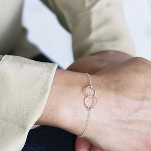 Detail of S925 sterling silver double interlocking circles bracelet on female wrist