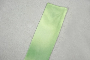 Close-up of light green ribbed fabric texture with detailed stitching and soft knit pattern