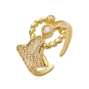Golden geometric open ring with white cubic zirconia and twisted rope details on white background