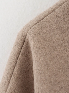 Détail de la couture d'épaule sur une veste épaisse en laine mélangée couleur camel