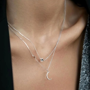 Elegant S925 sterling silver layered necklace featuring moon and star pendants with zircons