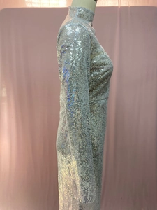 Close-up of sparkling silver sequins on this long sleeve high neck bodycon party dress