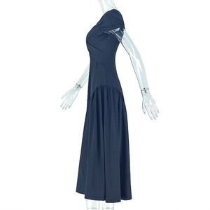 Detail of the elegant navy blue pleated dress featuring a V-neckline and backless design
