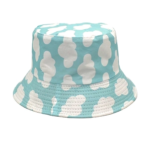 Detailed view of sky blue bucket hat with white clouds and reinforced stitched brim