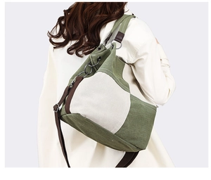 Rear view of a model wearing the olive and cream canvas tote bag with brown straps