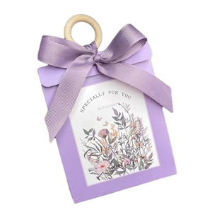 Purple wedding gift box with floral print, silk ribbon bow, and natural wooden handle
