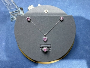 Three-piece jewelry set with pink heart stones and pavé accents in silver finish