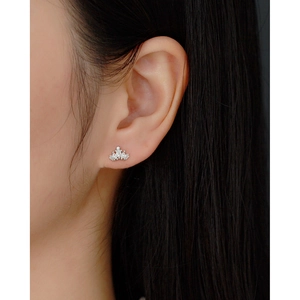 Close-up of a 925 sterling silver crown earring with sparkling cubic zirconia on ear