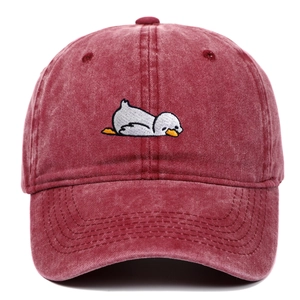 Detail of cartoon duck embroidery on washed cotton vintage style baseball cap