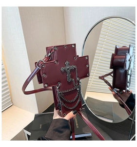 Detail view of burgundy gothic cross bag with rivets, metal chains and PU leather texture