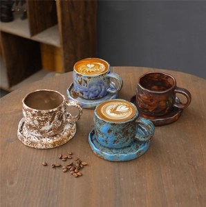 Detailed view of four vintage ceramic coffee cup and saucer sets with rustic textures