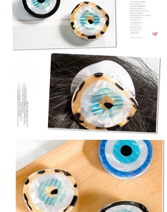 Macro view of evil eye acetate hair claw clip showing glossy texture and metal clamp