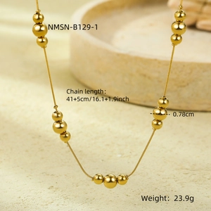 Macro detail of golden stainless steel beaded snake chain with triple ball design links