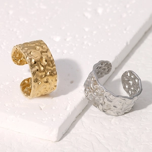 Detailed macro view of gold and silver rings with unique hand-hammered metal textures