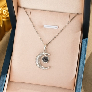 Silver crescent moon necklace with projection stone and zircons in a jewelry gift box