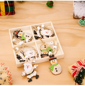Detail of wooden Christmas ornaments set with Santa and snowman figures in a wood box