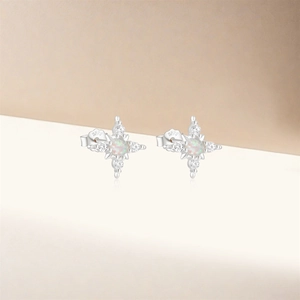 Close-up of S925 sterling silver starburst studs with opal and cubic zirconia stones