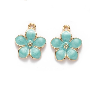 Close-up of blue enamel cherry blossom pendants with gold plating for DIY jewelry making