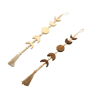 Handcrafted lunar eclipse wall hanging with wooden moon phases and cotton tassels