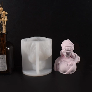 Macro detail of flexible silicone mold alongside a pink Greek goddess bust sculpture
