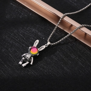 Macro shot of silver robot pendant with rabbit ears and a sparkling colorful gemstone