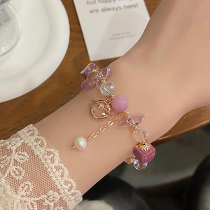 Detailed shot of amethyst crystal beaded bracelet with pearls on a wrist