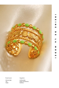 Detailed macro view of multilayer golden ring with green enamel and sun flower texture
