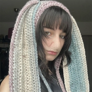 Detail of handmade crochet balaclava with long bunny ears in pink and blue yarn