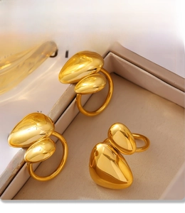 Detailed view of three irregular bean-shaped 18K gold-plated stainless steel rings