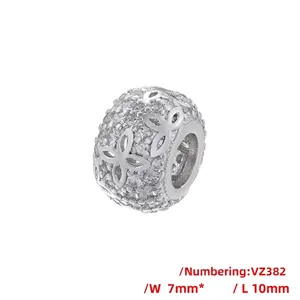 Detail view of 10mm copper hollow bead with zircon inlay and flower petal pattern