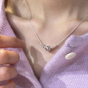 Elegant 925 sterling silver beaded necklace with round pendant worn by a model