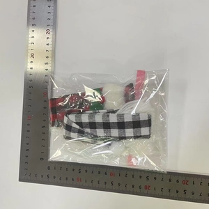 Detailed view of Christmas buffalo plaid wine bottle covers measured with steel rulers