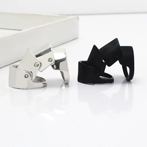 Close-up of silver polished and black matte articulated joint armor rings on a white base