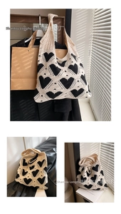 Close-up of heart-patterned knitted tote bag with contrast crochet texture and soft handle