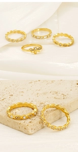 Detail of 18K gold-plated stacking rings with bee motif and sparkling zircon stones