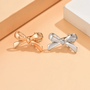 Metallic bow hair clips in gold and silver finish for elegant hair styling