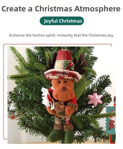 Close-up of a plush Christmas reindeer ornament with a plaid hat on a green tree branch