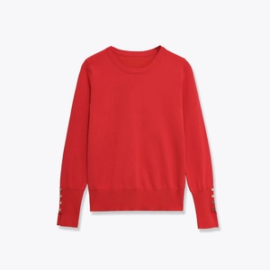 Women's red crewneck knit sweater featuring elegant gold button cuffs on long sleeves