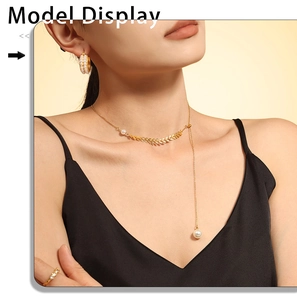 Close-up of elegant gold wheat ear pendant necklace with pearls on a female model