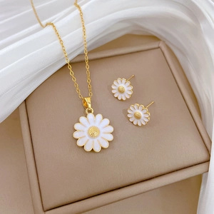 Daisy pendant necklace and stud earrings set in gold stainless steel with white enamel